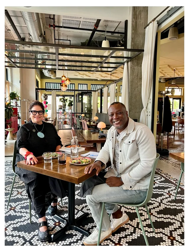 Kevin King seated with a guest at a restaurant