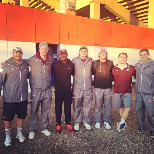 Group of coaches and athletes posing together
