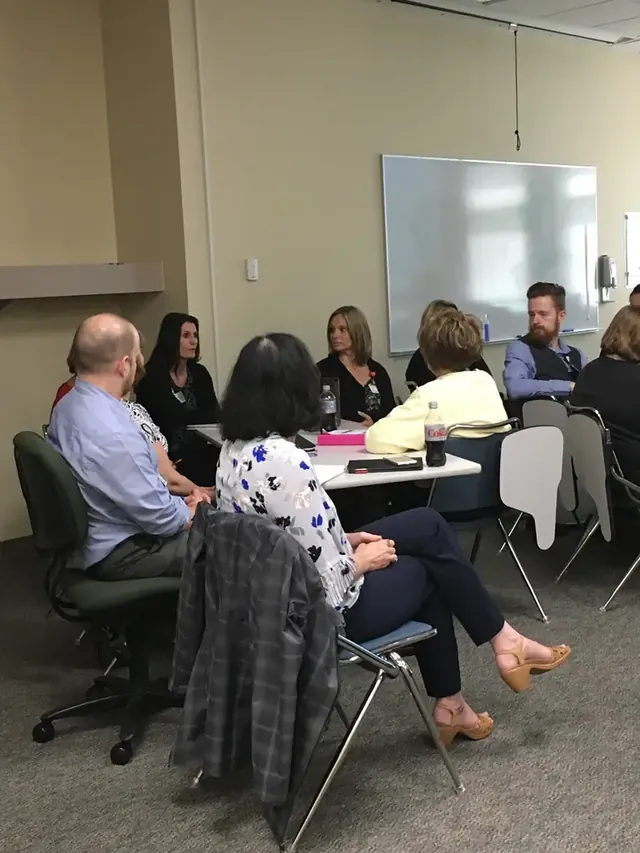 Participants discussing an activity around a table