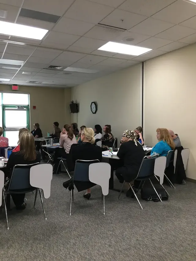 Participants gathered around workshop tables