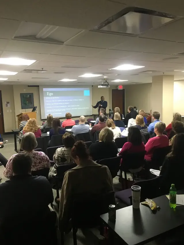 Audience watching a presentation in a conference room